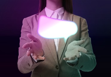 Image of Communication and dialogue concept. Businesswoman with illustration of speech bubble on dark background, closeup