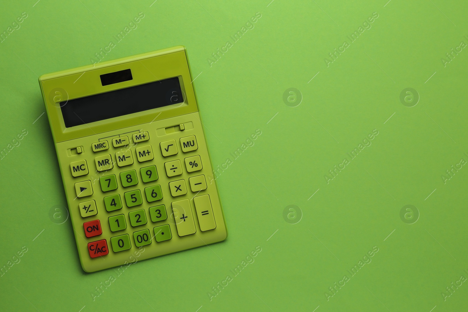 Photo of Modern calculator on green background, top view. Space for text