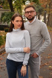 Couple wearing stylish clothes in autumn park