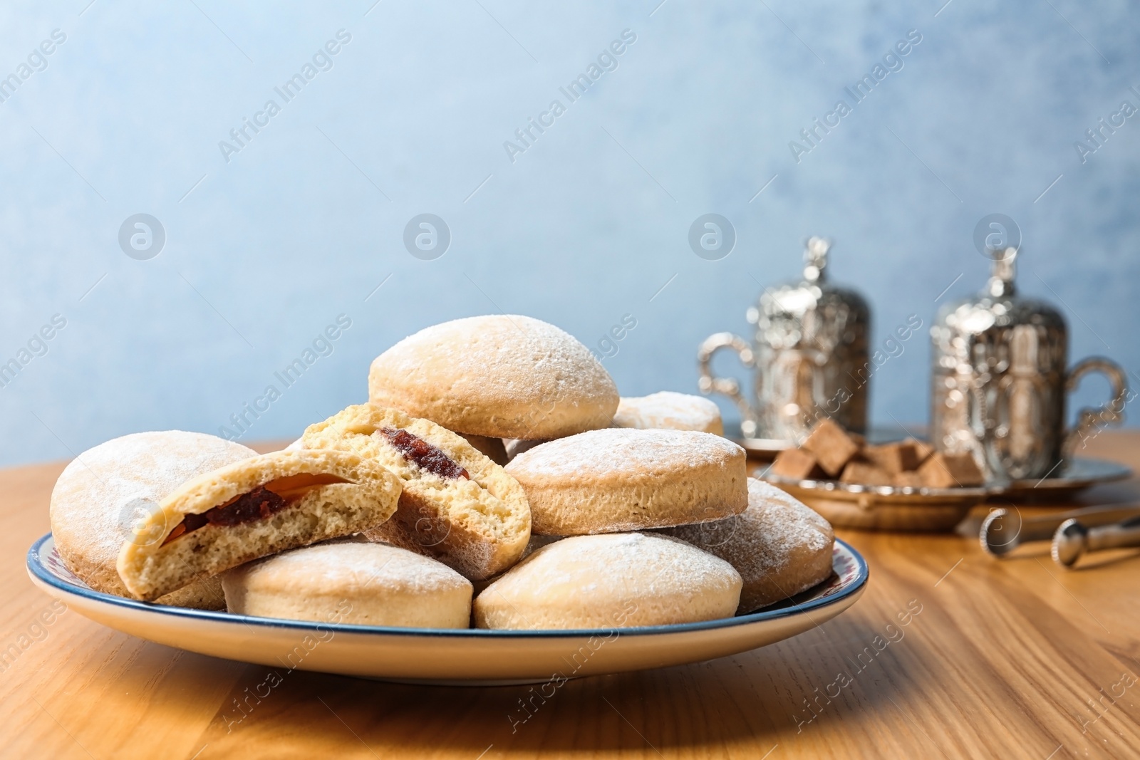 Photo of Plate of traditional cookies for Islamic holidays on table, space for text. Eid Mubarak