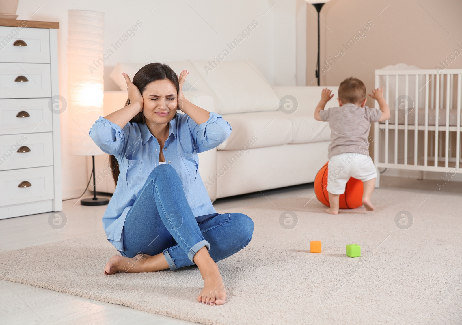 Photo of Young mother suffering from postnatal depression and cute baby boy at home