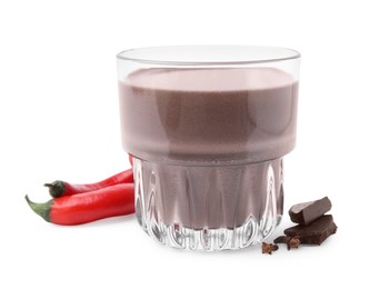 Photo of Glass of hot chocolate with chili peppers on white background