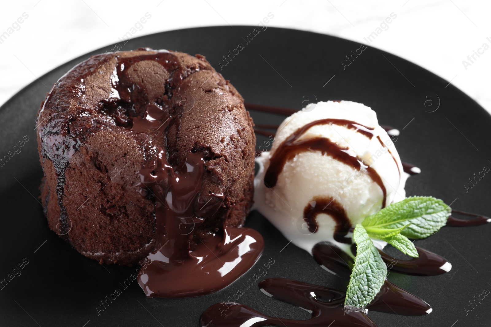 Photo of Delicious fresh fondant with hot chocolate and ice cream served on plate. Lava cake recipe