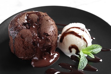 Delicious fresh fondant with hot chocolate and ice cream served on plate. Lava cake recipe