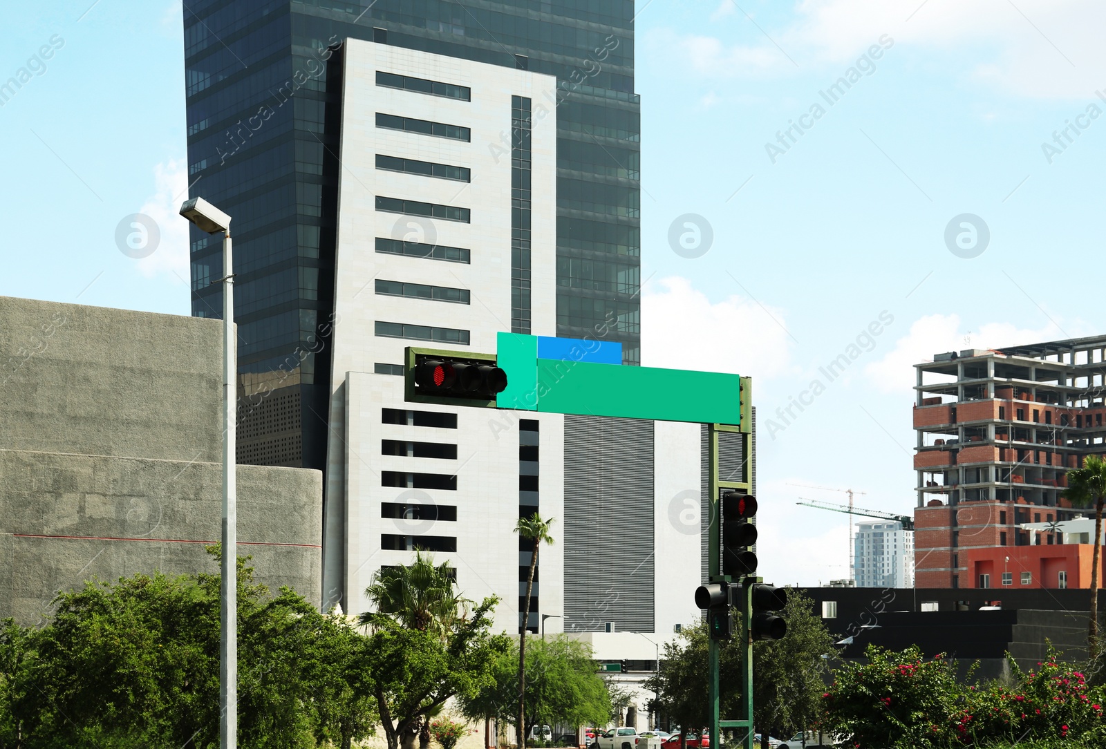 Photo of Traffic lights with red sign on city street. Road rules