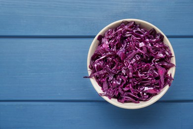 Photo of Tasty red cabbage sauerkraut on light blue wooden table, top view. Space for text