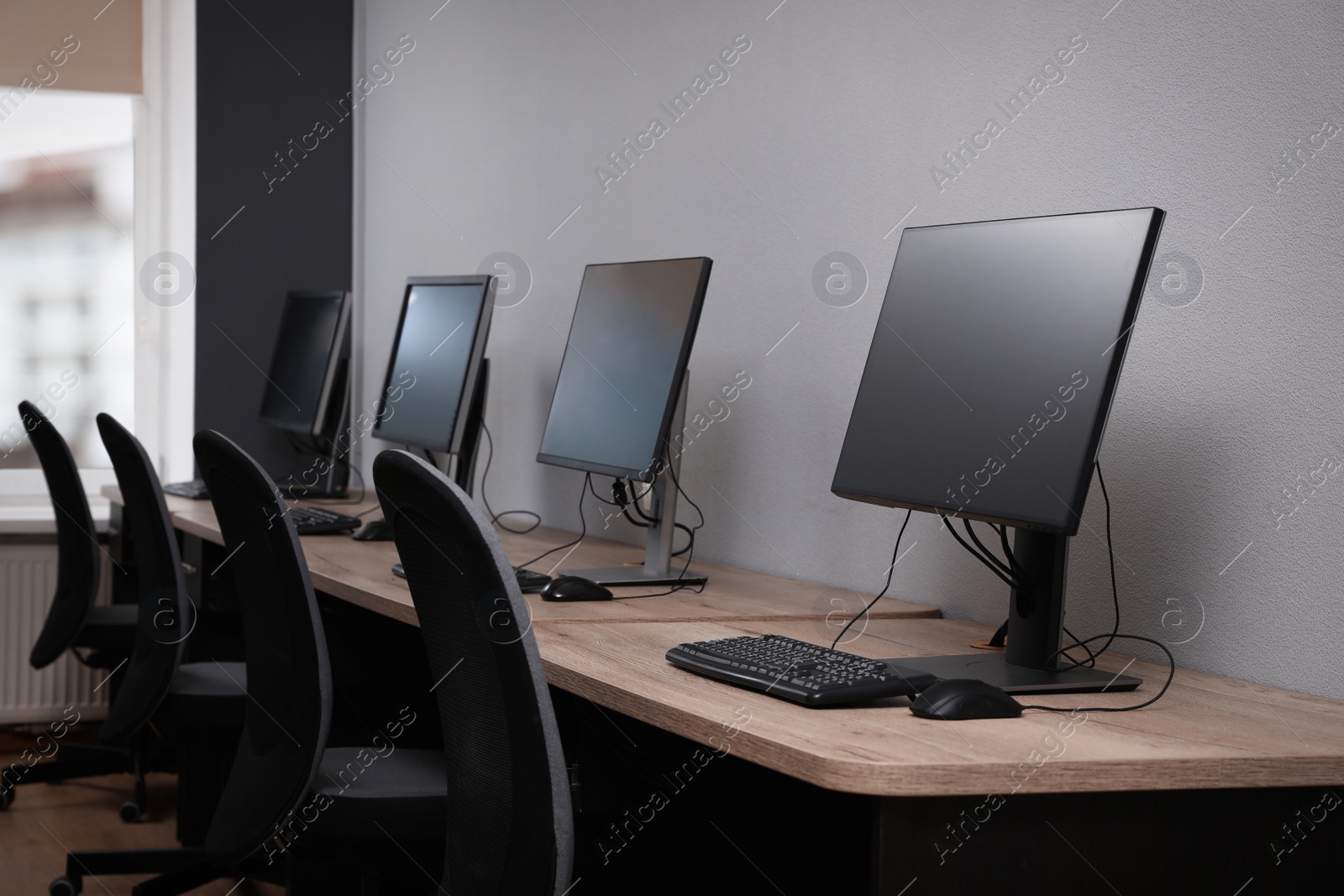 Photo of Many modern computers in open space office