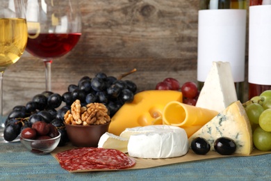 Photo of Composition with wine and snacks on table