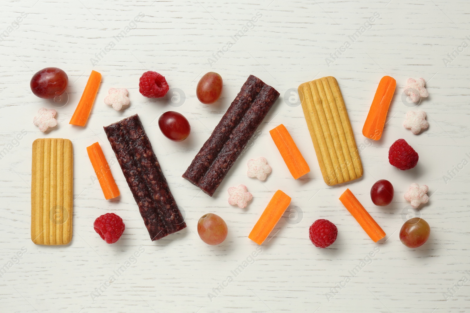 Photo of Flat lay composition with different finger foods for baby on white wooden table