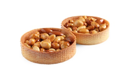Photo of Tartlets with caramelized nuts isolated on white. Tasty dessert