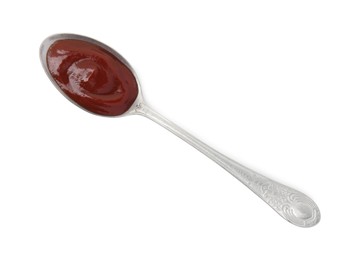 Photo of Tasty barbecue sauce in spoon isolated on white, top view