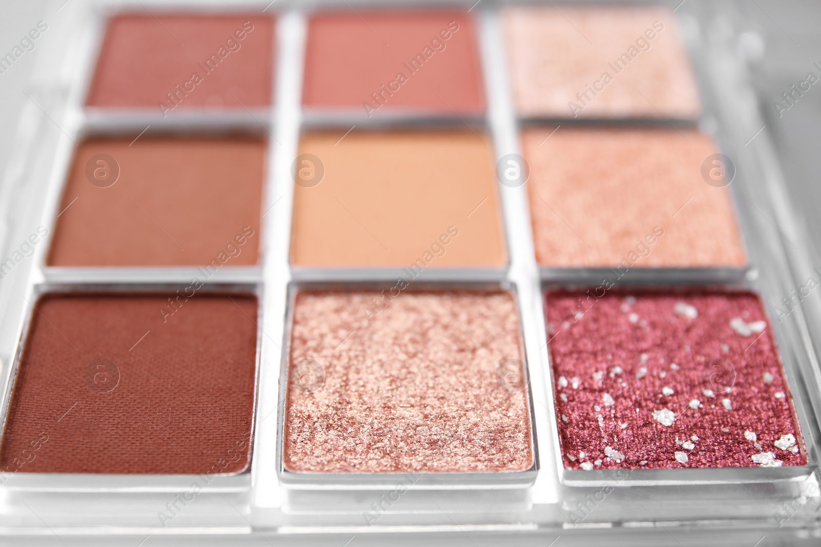 Photo of Beautiful eyeshadow palette as background, closeup. Professional cosmetic product