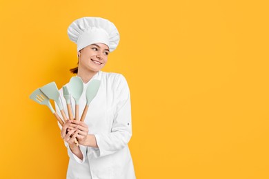 Photo of Professional chef with kitchen utensils on yellow background. Space for text