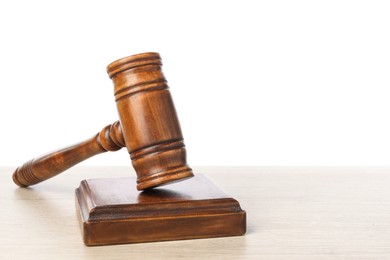 Photo of Wooden gavel on light table against white background. Space for text