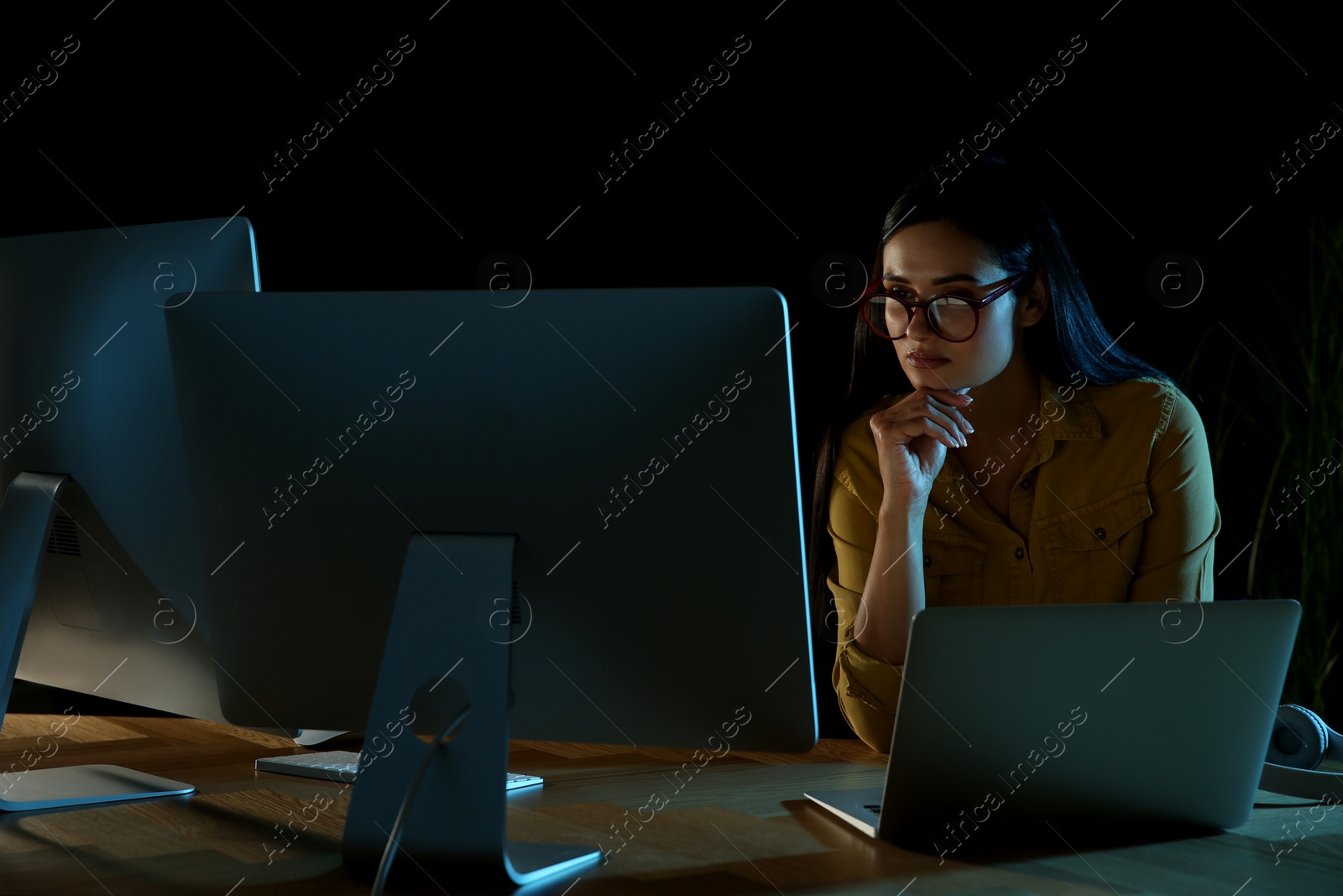 Photo of Programmer working in modern office at night