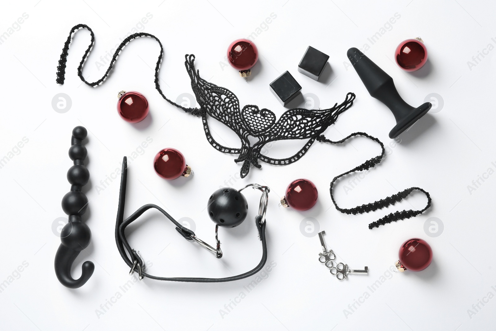 Photo of Set of different sex toys and Christmas balls on white background, top view