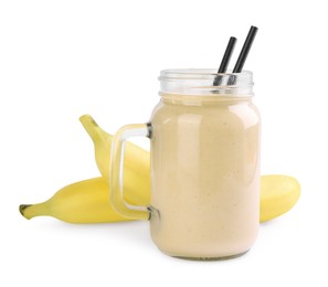 Photo of Mason jar with smoothie and bananas on white background