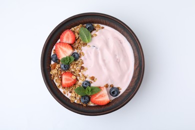 Photo of Bowl with yogurt, berries and granola isolated on white, top view