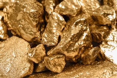 Photo of Pile of gold nuggets as background, closeup