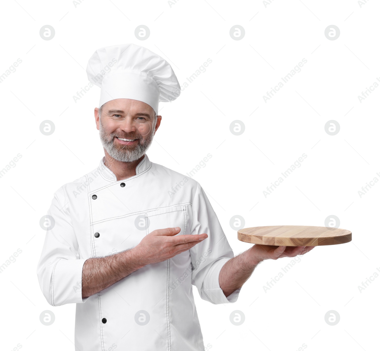 Photo of Happy chef in uniform pointing at wooden board on white background