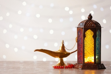 Composition with Muslim lamp Fanus and space for design on blurred lights background