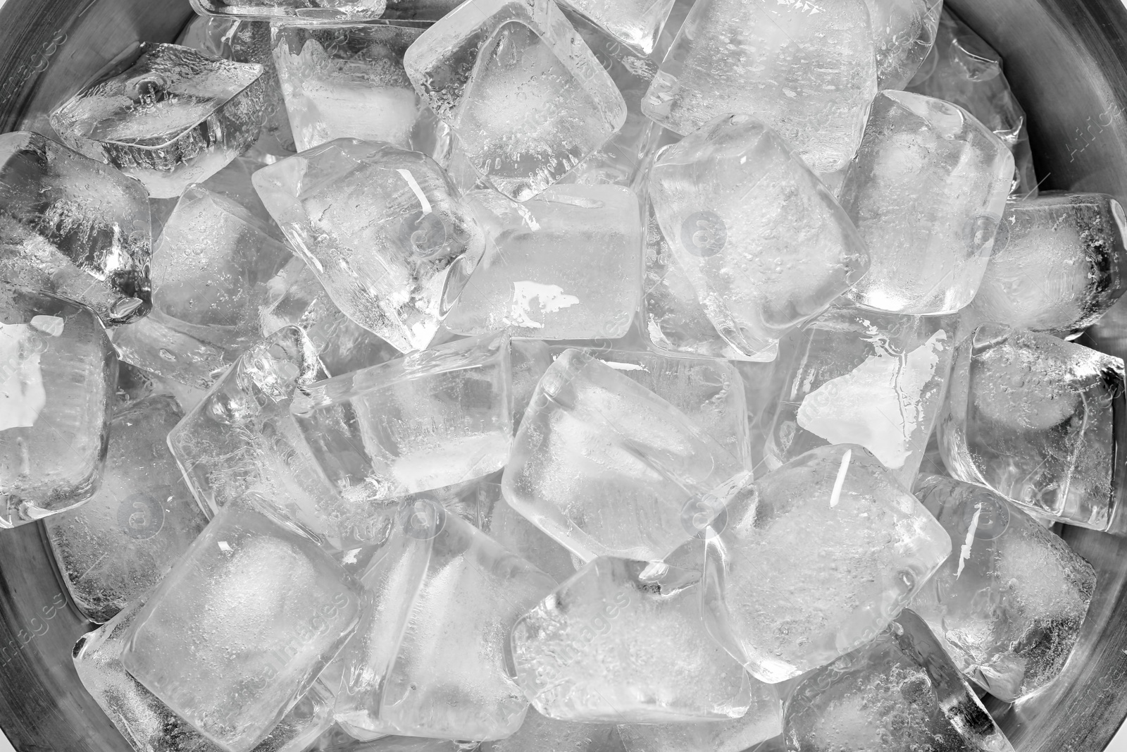 Photo of Bucket with ice cubes as background, closeup