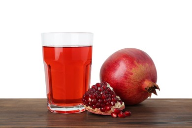 Photo of Refreshing pomegranate juice in glass, leaves and seeds on wooden table against white background