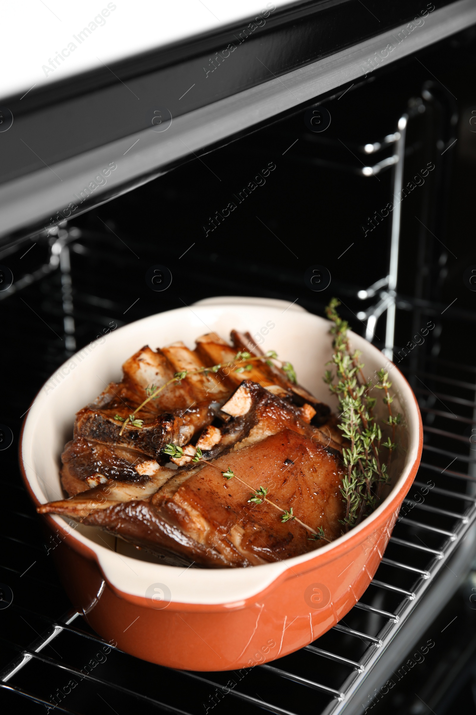 Photo of Delicious roasted ribs with thyme in oven