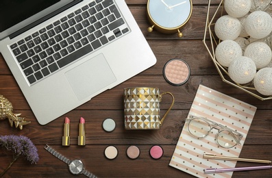 Flat lay composition with laptop, cosmetics and stylish accessories on wooden background. Blogger concept