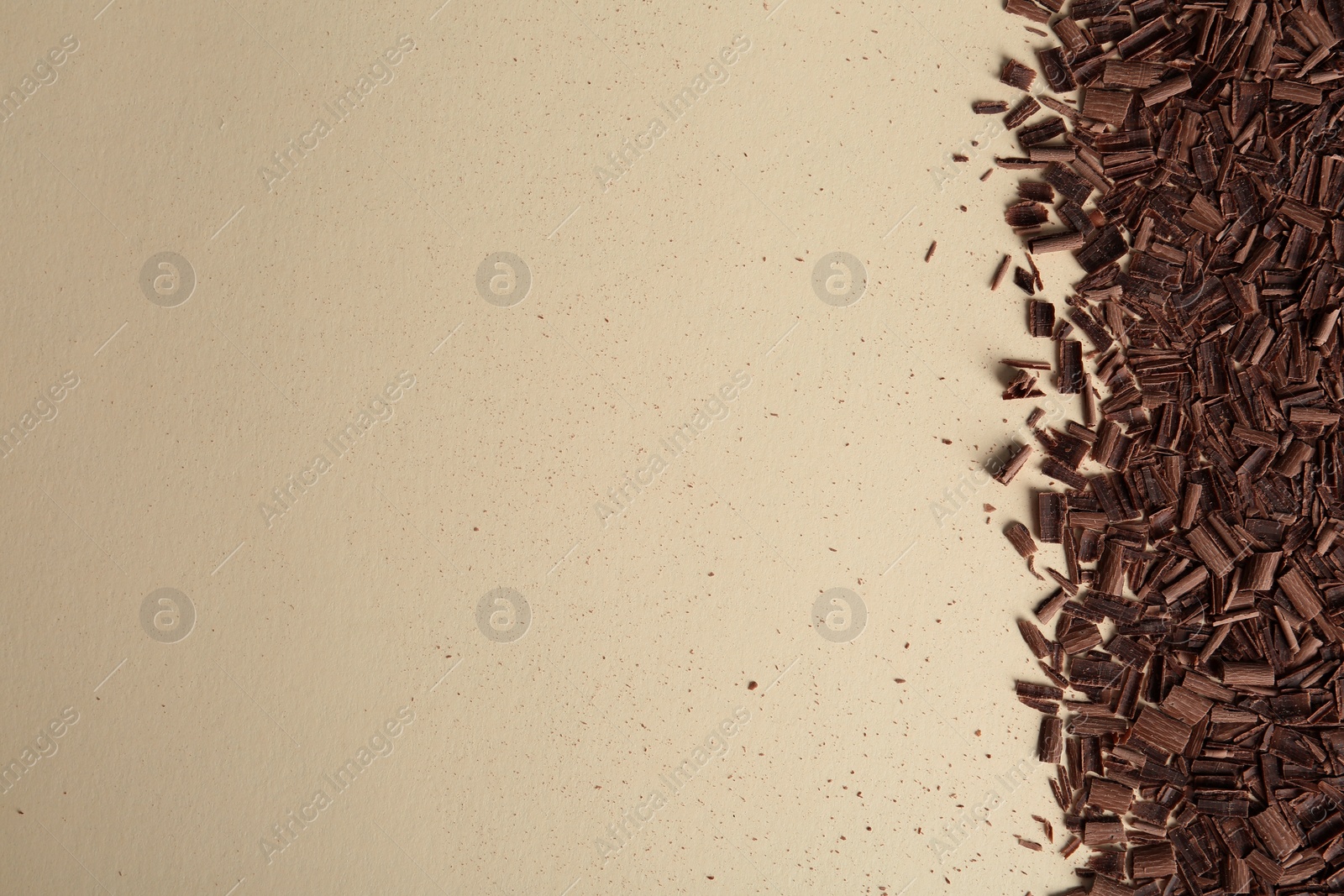 Photo of Chocolate curls and space for text on color background, top view