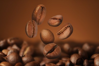 Image of Falling aromatic roasted coffee beans, closeup view