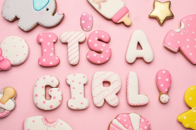 Phrase IT IS A GIRL and tasty cookies on pink background, flat lay. Baby shower party