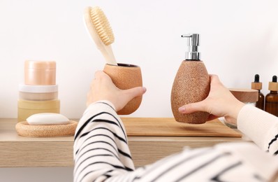 Photo of Bath accessories. Woman with different personal care products indoors, closeup