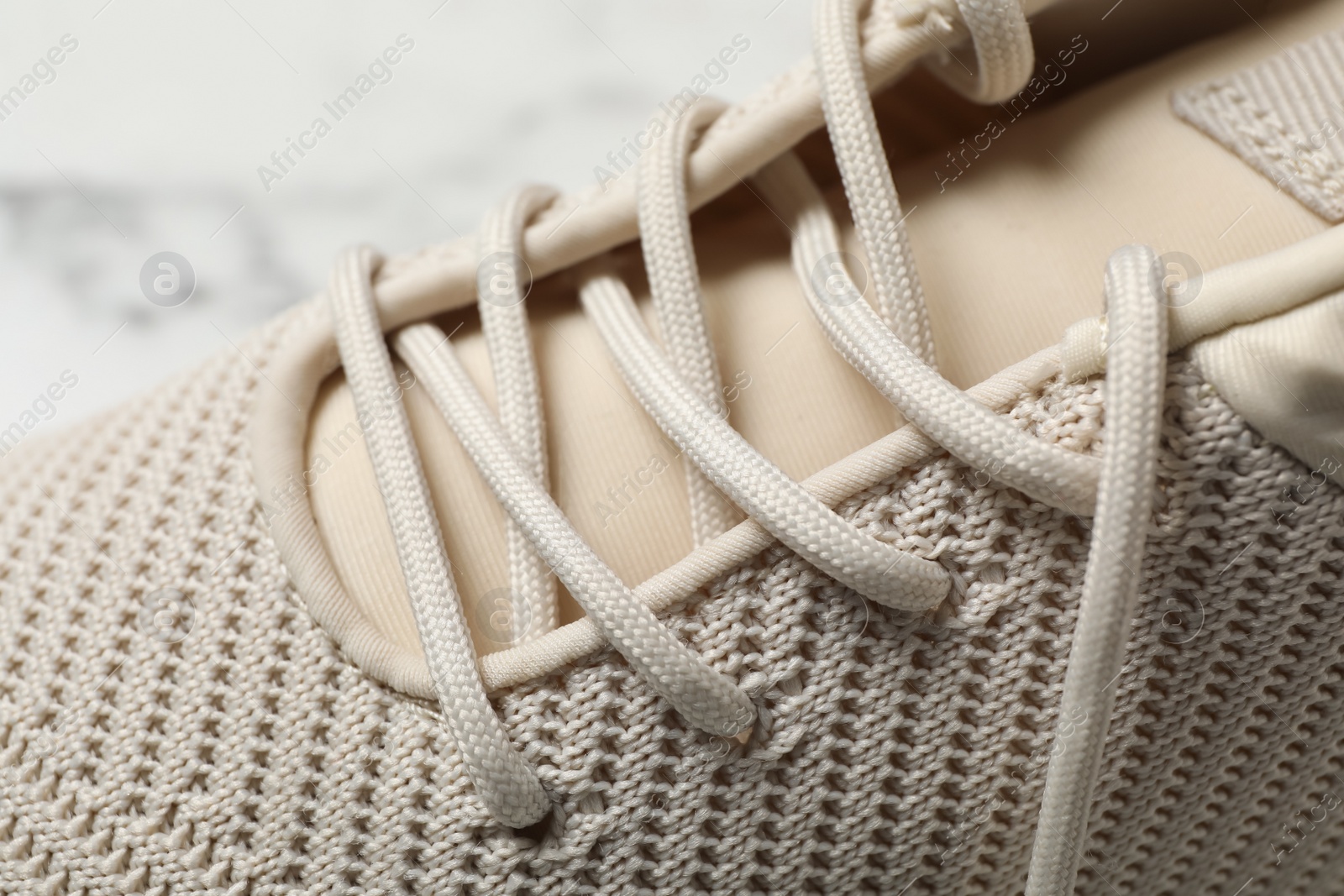 Photo of Stylish shoe with beige laces, closeup view