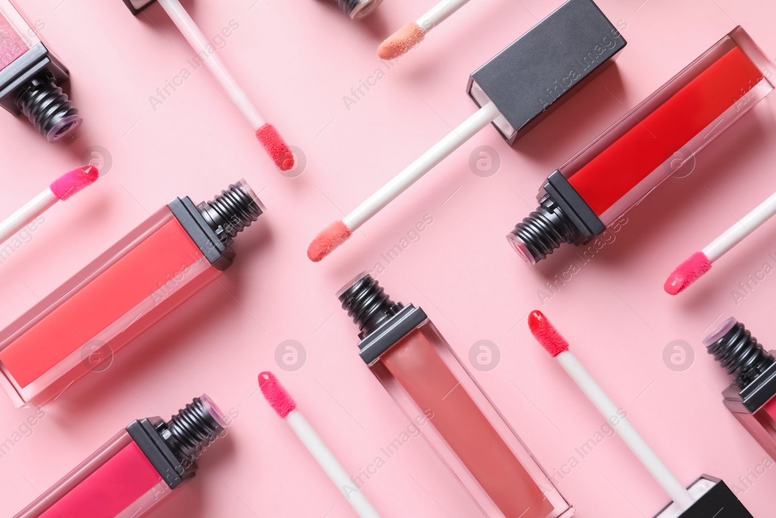 Photo of Composition of liquid lipsticks on color background, flat lay