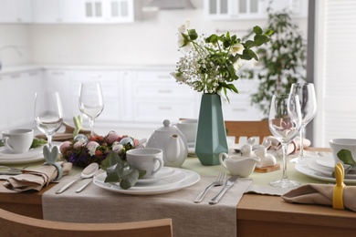 Photo of Beautiful Easter table setting with festive decor indoors