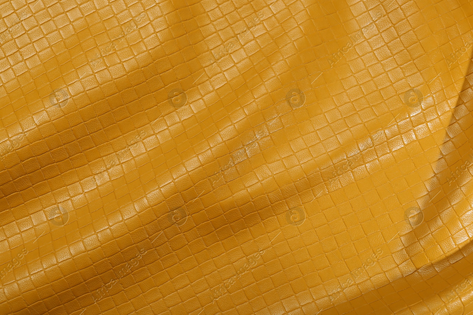 Photo of Beautiful yellow leather as background, top view