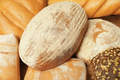 Different freshly baked breads as background, view from above