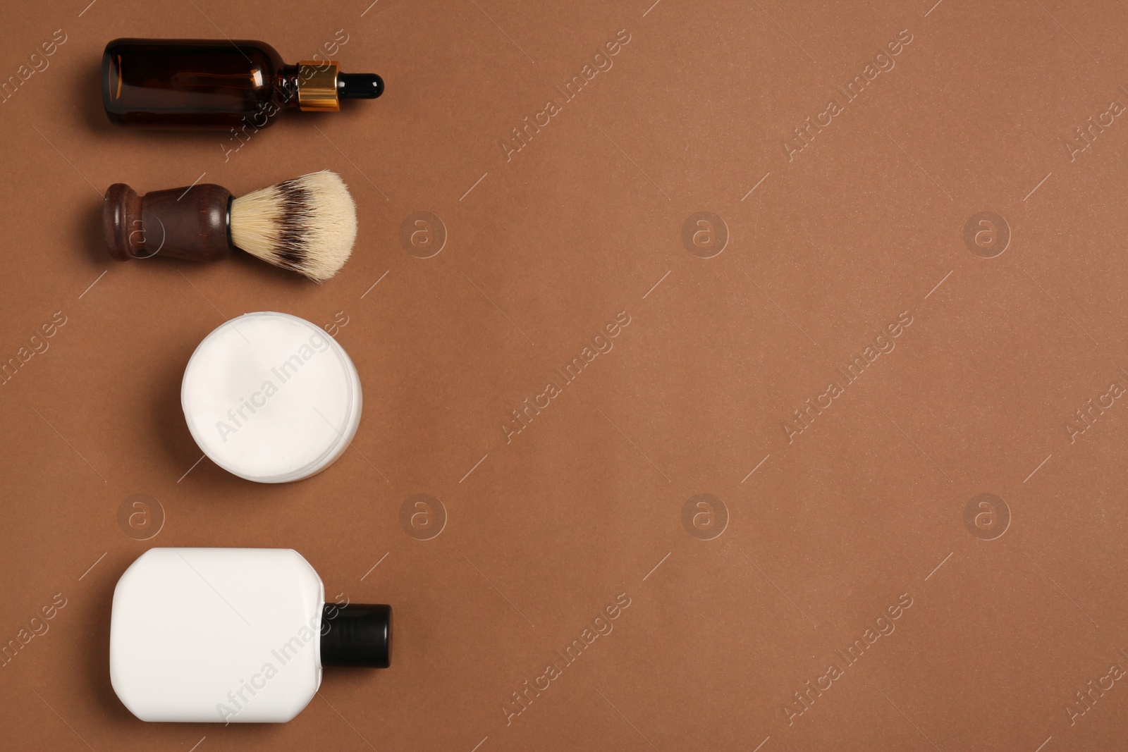 Photo of Set of men's shaving tools on brown background, flat lay. Space for text