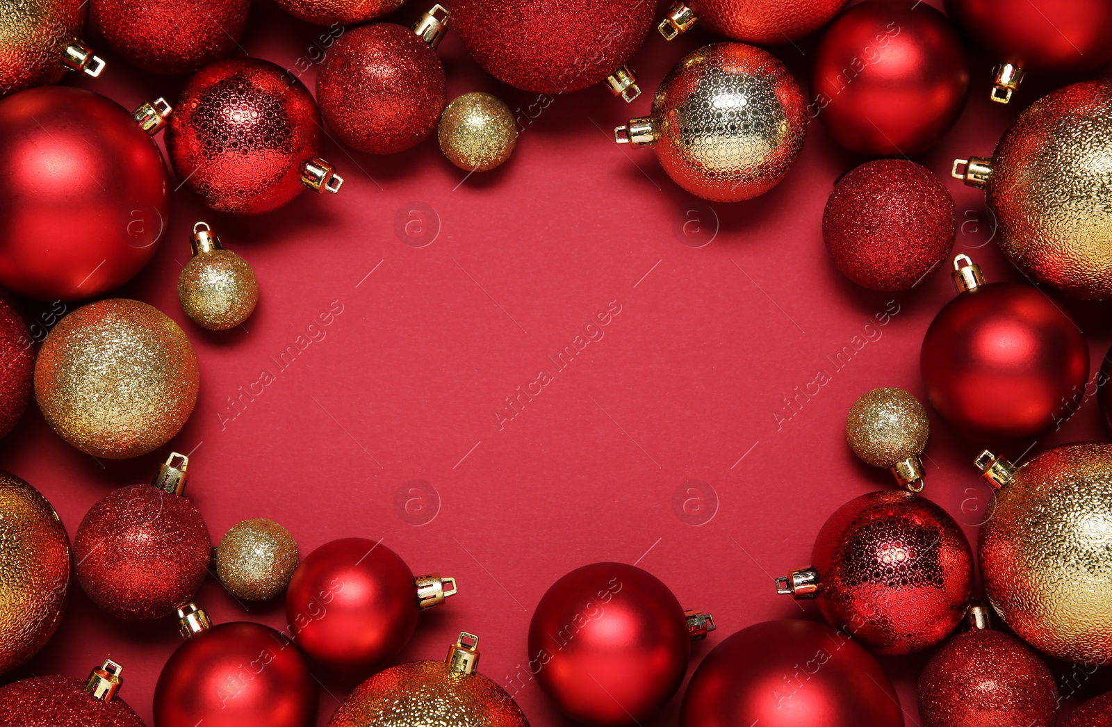 Photo of Frame of beautiful Christmas balls on red background, top view. Space for text