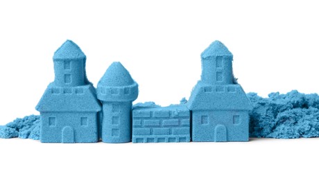 Photo of Castle made of blue kinetic sand isolated on white