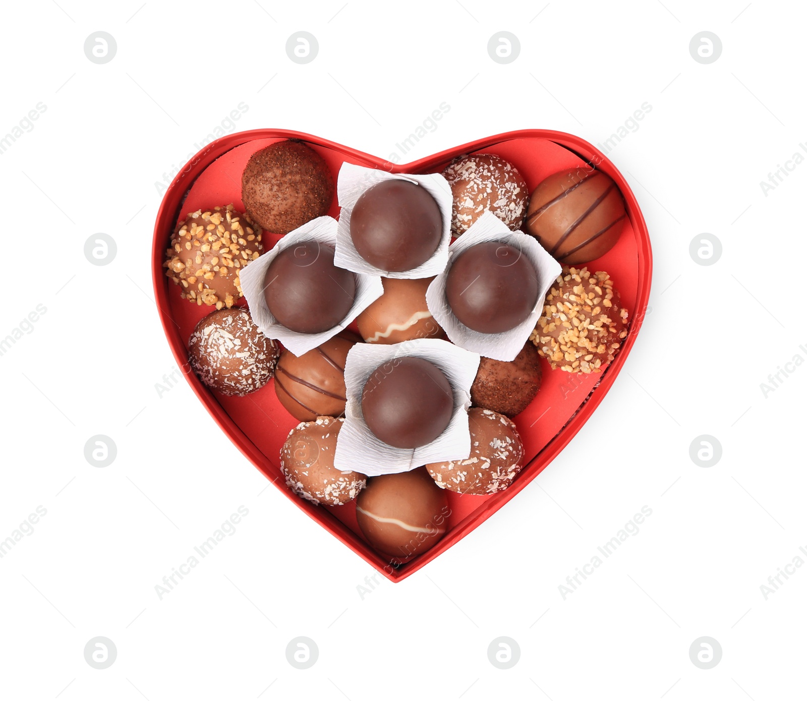 Photo of Heart shaped box with delicious chocolate candies isolated on white, top view