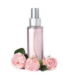 Bottle with rose essential oil and flowers on white background