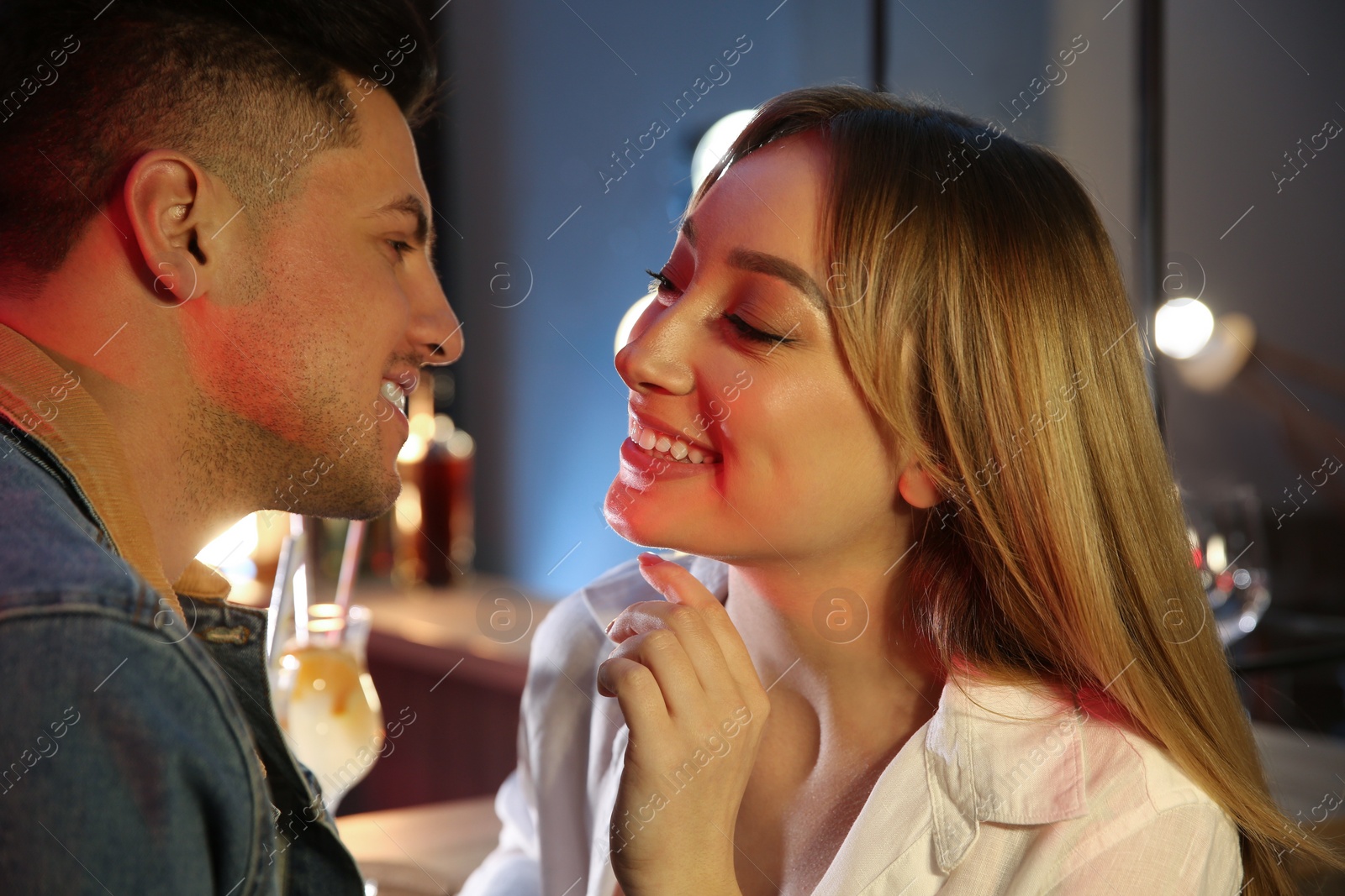 Photo of Man and woman flirting with each other in bar