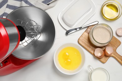 Photo of Modern red stand mixer and different ingredients on white table, flat lay