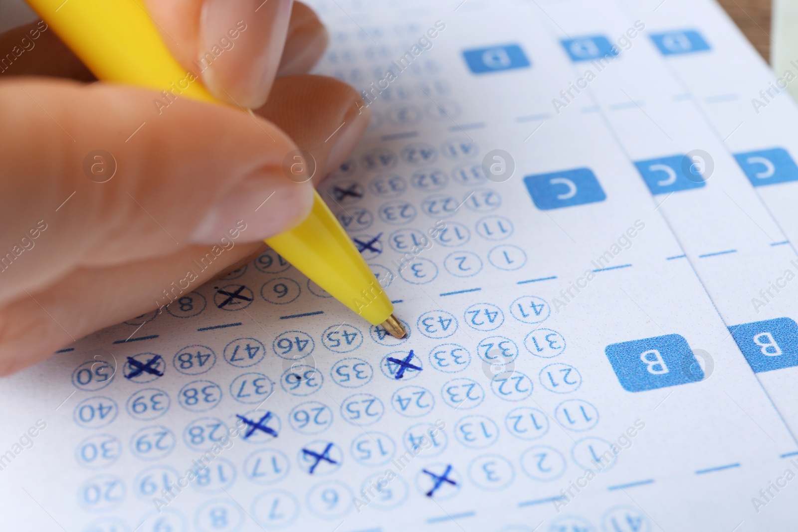 Photo of Woman filling out lottery tickets with pen, closeup