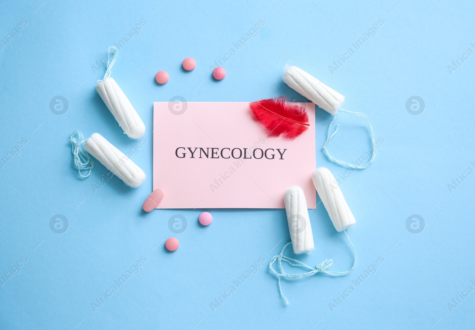 Photo of Flat lay composition with card, pills and tampons on color background. Gynecological care