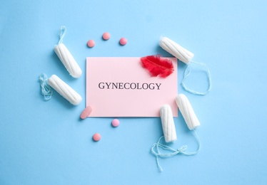 Flat lay composition with card, pills and tampons on color background. Gynecological care