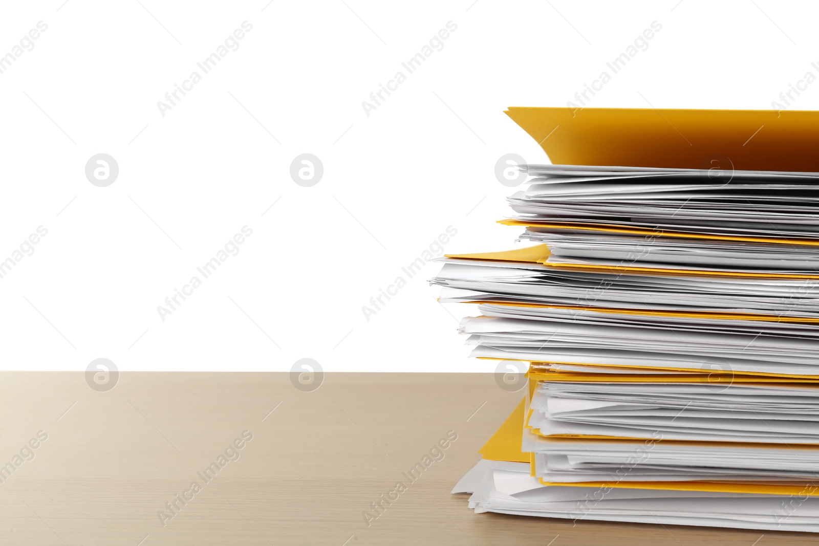 Photo of Stack of yellow files with documents on wooden table against white background. Space for text