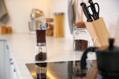 Photo of Manual coffee grinder on countertop in kitchen